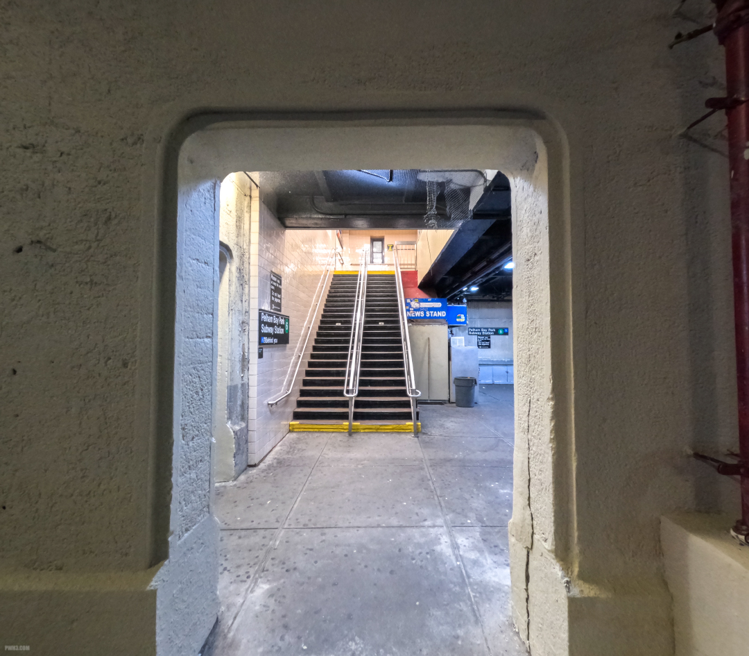 A staircase leading to the upper platform of a subway station.